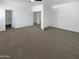 Spacious bedroom with neutral carpet, white walls, and multiple doors leading to closets and other areas at 5140 W Bent Tree Dr, Phoenix, AZ 85083