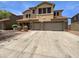 Charming two-story home showcasing a three-car garage and an inviting stone-accented entryway at 5140 W Bent Tree Dr, Phoenix, AZ 85083