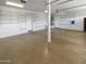 Bright garage with ample shelving, offering organized storage solutions and convenience at 5140 W Bent Tree Dr, Phoenix, AZ 85083
