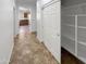 Bright hallway featuring tile flooring and a storage closet with shelving, adding practicality at 5140 W Bent Tree Dr, Phoenix, AZ 85083