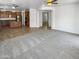 Bright and airy living room with plush carpeting, seamlessly connects to the kitchen at 5140 W Bent Tree Dr, Phoenix, AZ 85083