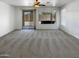 Bright living room with plush carpeting, offering mountain views through sliding doors and windows at 5140 W Bent Tree Dr, Phoenix, AZ 85083