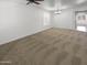 Bright carpeted living room features white walls and ample natural light at 5140 W Bent Tree Dr, Phoenix, AZ 85083