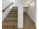 Carpeted stairway with wooden handrail and baseboard leading to the upper level and connecting to the lower level at 5140 W Bent Tree Dr, Phoenix, AZ 85083
