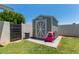 Charming backyard features a storage shed with adjacent block wall and green grass at 6302 N 13Th Pl, Phoenix, AZ 85014