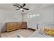 Bright bedroom features a crib and toddler bed, ceiling fan and white walls and shutters for a clean look at 6302 N 13Th Pl, Phoenix, AZ 85014
