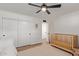 Bright bedroom features a crib and closet storage, ceiling fan and white walls for a clean look at 6302 N 13Th Pl, Phoenix, AZ 85014