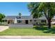 Charming single-story home featuring a well-manicured lawn, covered porch and stylish architectural details at 6302 N 13Th Pl, Phoenix, AZ 85014