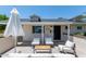 Inviting front patio with comfortable seating and shade umbrella for relaxation at 6302 N 13Th Pl, Phoenix, AZ 85014