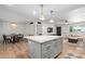 Open concept living space includes a large kitchen island, dining area, and comfortable seating with great natural light at 6302 N 13Th Pl, Phoenix, AZ 85014