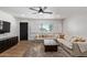 Cozy living room features a comfortable sectional sofa, wood floors, and bright window at 6302 N 13Th Pl, Phoenix, AZ 85014