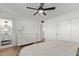 Bright main bedroom features neutral tones, ceiling fan, wood floors and ensuite bathroom for convenience at 6302 N 13Th Pl, Phoenix, AZ 85014