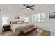 Bright bedroom with natural light showcases a cozy bed, minimalist art, and a leather bench at 6302 N 13Th Pl, Phoenix, AZ 85014