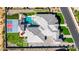 Aerial view of a residence featuring a pool, basketball court, and putting green in a well-landscaped yard at 7482 S Mccormick Way, Queen Creek, AZ 85142