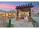 Backyard patio with a pergola, built-in grill, and access to the pool area at 7482 S Mccormick Way, Queen Creek, AZ 85142