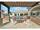 Luxury backyard with a covered patio, BBQ area, and stunning pool with a waterfall feature at 7482 S Mccormick Way, Queen Creek, AZ 85142