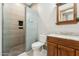 Modern bathroom featuring a glass shower and a wooden vanity with marble countertop at 7482 S Mccormick Way, Queen Creek, AZ 85142