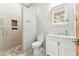Bright bathroom features a walk-in shower with river rock floor, a white vanity and marble countertops at 7482 S Mccormick Way, Queen Creek, AZ 85142