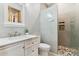 Bright bathroom with a glass shower and a white vanity with marble countertop at 7482 S Mccormick Way, Queen Creek, AZ 85142