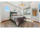 Well-lit bedroom with a large window, ceiling fan, cozy carpet and stylish decor at 7482 S Mccormick Way, Queen Creek, AZ 85142