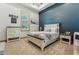 Comfortable bedroom featuring a white wood bed frame, wood shutters, and blue accent wall at 7482 S Mccormick Way, Queen Creek, AZ 85142