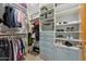 Walk-in closet featuring shelves, hanging racks, and blue storage drawers at 7482 S Mccormick Way, Queen Creek, AZ 85142