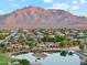 A neighborhood nestled with mountain views showcases lush landscaping, serene lakes, and luxurious waterfront homes at 7482 S Mccormick Way, Queen Creek, AZ 85142