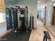 Well-equipped exercise room with workout machine, weights, mirrors, and neutral color palette at 7482 S Mccormick Way, Queen Creek, AZ 85142