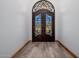 Interior view of the detailed iron and glass front doors, with a view of the tiled flooring at 7482 S Mccormick Way, Queen Creek, AZ 85142