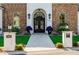 Close-up of the front entrance with ornate iron double doors, stone pillars, and a paved walkway at 7482 S Mccormick Way, Queen Creek, AZ 85142