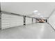 Large garage with an epoxy floor and four garage doors at 7482 S Mccormick Way, Queen Creek, AZ 85142