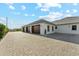 Spacious four car garage with pavers leading to the entrance at 7482 S Mccormick Way, Queen Creek, AZ 85142