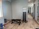 Home gym with dumbbell rack, exercise bench, and wall mirror; ideal for fitness enthusiasts at 7482 S Mccormick Way, Queen Creek, AZ 85142