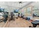 Well-equipped home gym with exercise machines, ample mirrors, and wood flooring at 7482 S Mccormick Way, Queen Creek, AZ 85142