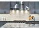 Close-up of kitchen with stainless hood and tile backsplash at 7482 S Mccormick Way, Queen Creek, AZ 85142