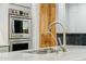 Modern stainless steel oven and faucet over marble countertop at 7482 S Mccormick Way, Queen Creek, AZ 85142