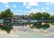 Picturesque lakeside view featuring a grand home with private dock, complemented by a serene body of water at 7482 S Mccormick Way, Queen Creek, AZ 85142
