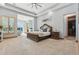 Spacious main bedroom with a luxurious bed, sitting area, and walk-in closet at 7482 S Mccormick Way, Queen Creek, AZ 85142