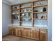Stylish home office featuring custom built-in shelves and cabinetry, perfect for organization and display at 7482 S Mccormick Way, Queen Creek, AZ 85142