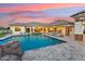 Expansive backyard featuring a beautiful pool, lounge area, and outdoor entertaining space at 7482 S Mccormick Way, Queen Creek, AZ 85142
