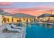 Luxurious backyard with a large pool, lounge chairs, and outdoor bar area for relaxation at 7482 S Mccormick Way, Queen Creek, AZ 85142