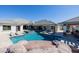 Aerial view of a backyard pool and spa alongside outdoor seating and an outdoor kitchen at 7482 S Mccormick Way, Queen Creek, AZ 85142