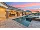 Stunning backyard pool area with a spa, outdoor kitchen, and covered lounge seating at 7482 S Mccormick Way, Queen Creek, AZ 85142