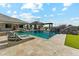 Inviting backyard oasis with a private pool, waterfall feature, and luxurious lounge seating at 7482 S Mccormick Way, Queen Creek, AZ 85142