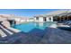 Backyard pool featuring a rock waterfall, in-ground jacuzzi, and lounge seating at 7482 S Mccormick Way, Queen Creek, AZ 85142