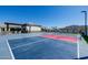 Well-equipped multi-sport court including basketball and tennis, next to a well-manicured backyard at 7482 S Mccormick Way, Queen Creek, AZ 85142