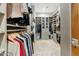 This spacious walk-in closet features custom shelving and hanging rods for optimal storage at 7482 S Mccormick Way, Queen Creek, AZ 85142