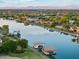 Luxury waterfront homes along a serene lake, complete with private boat docks, offering an idyllic lakeside living experience at 7482 S Mccormick Way, Queen Creek, AZ 85142