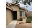 View of the home's covered front entryway featuring a covered porch and desert landscaping at 7771 N 58Th Ln, Glendale, AZ 85301