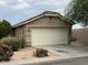 Single Gathering home featuring an attached two-car garage, desert landscaping, and a red tile roof at 7771 N 58Th Ln, Glendale, AZ 85301
